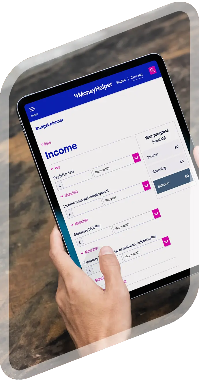 A person completing a personal budget planner on an iPad.