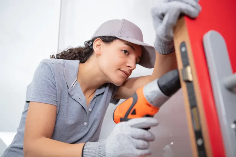 Tradeswoman repairing a door handle